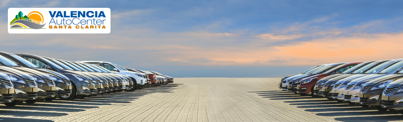 Wide-angle view of new and pre-owned vehicles lined up at Valencia Auto Center