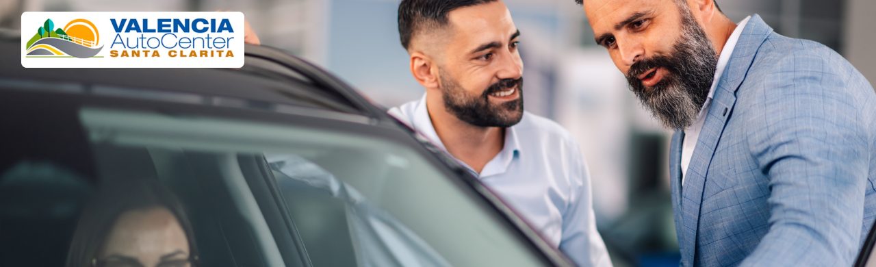 Close-up of a happy couple standing next to their newly purchased SUV at Valencia Auto Center in Santa Clarita