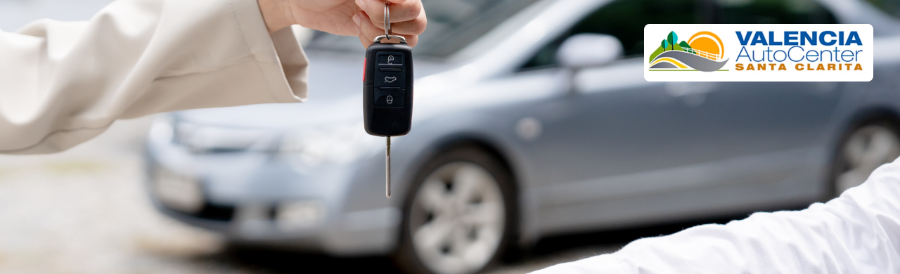  Customer reviewing warranty details on a certified pre-owned car at Valencia Auto Center.