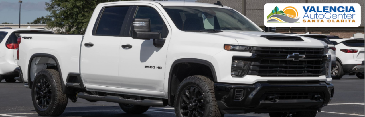 Used Chevy trucks lined up at Valencia Auto Center in Santa Clarita