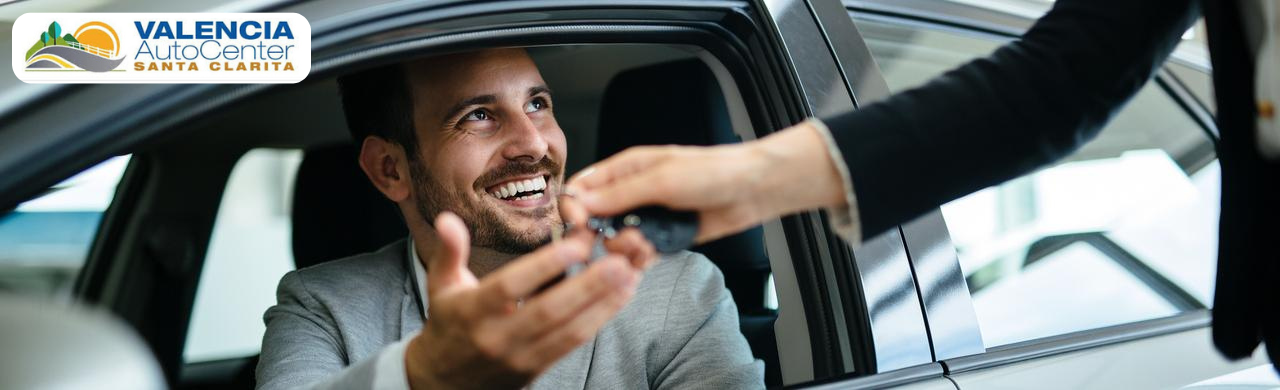 Customers browsing vehicles at Valencia Auto Center in Santa Clarita