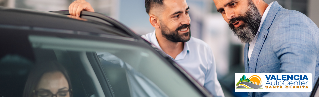 A happy customer drives away in their newly purchased vehicle from Valencia Auto Center in Santa Clarita, CA.