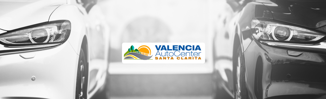 Customer exploring a luxury sedan interior with advanced features at Valencia Auto Center