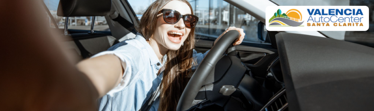 Happy customers test-driving a new car at Valencia Auto Center in Santa Clarita