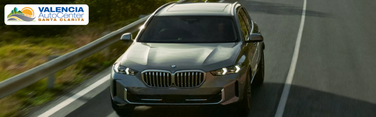 BMW 3 Series sedan parked in front of Valencia Auto Center with surrounding luxury cars