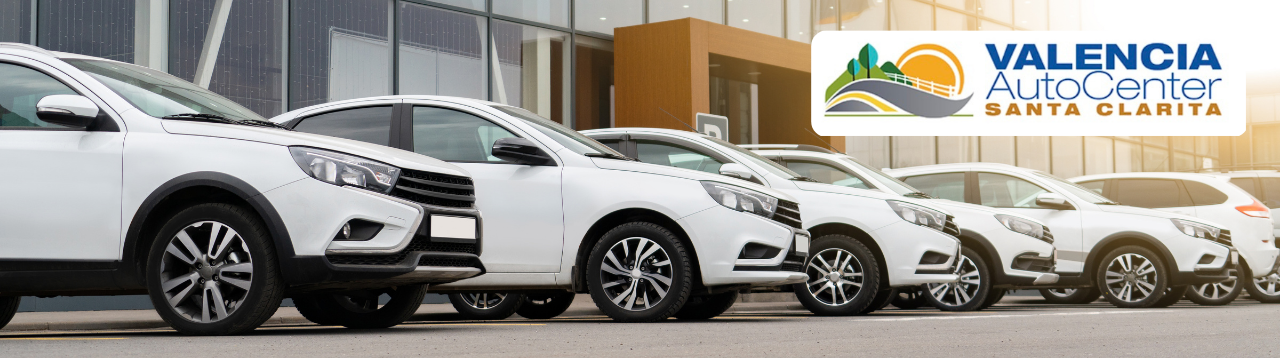Shiny new sedans and SUVs lined up on the Valencia Auto Center inventory lot