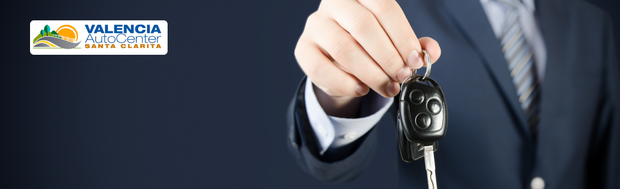 Customer receiving keys to their newly purchased car from Valencia Auto Center