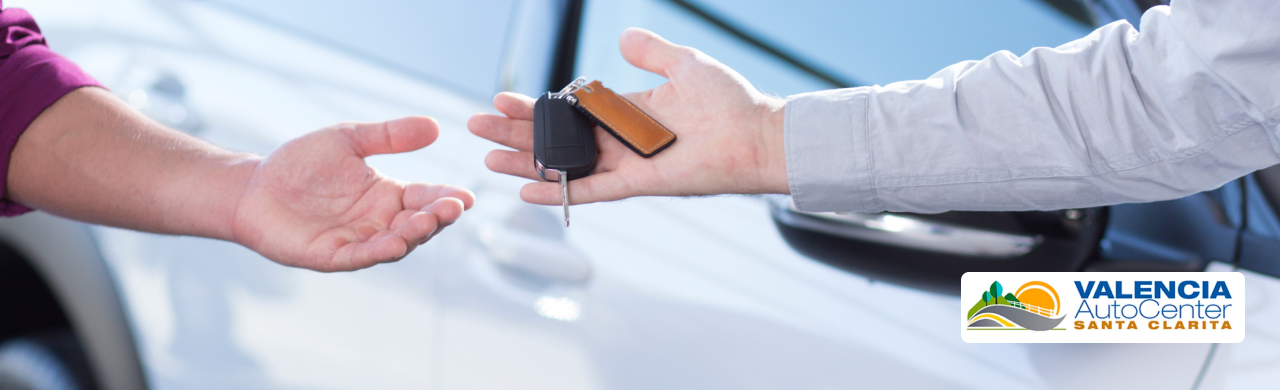 Customer test-driving a pre-owned vehicle at Valencia Auto Center