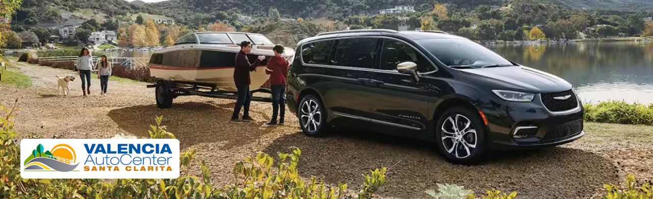A lineup of used Chrysler cars and minivans displayed at Valencia Auto Center in Santa Clarita, CA.