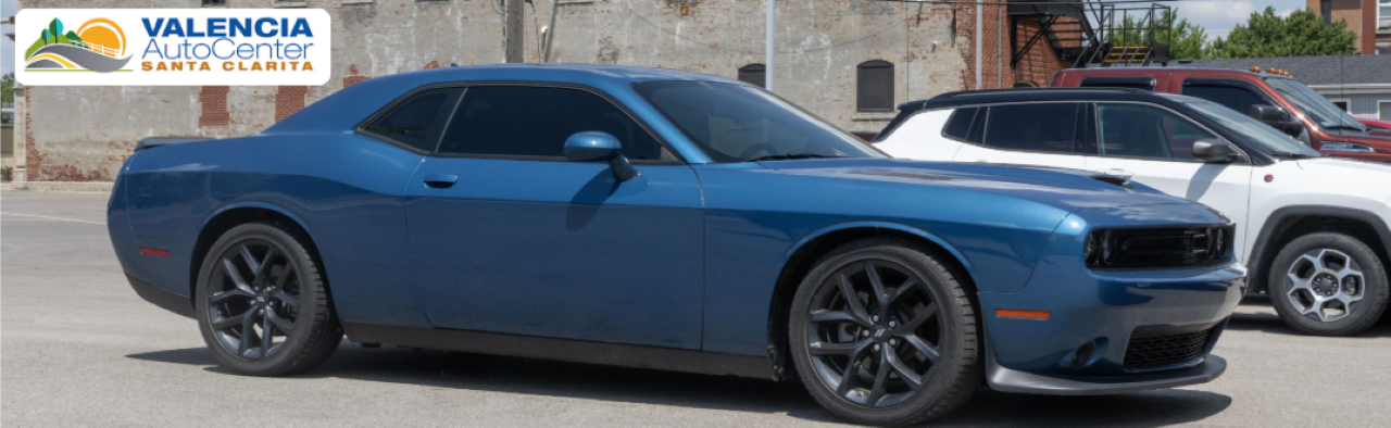 A selection of used Dodge cars and SUVs parked at Valencia Auto Center in Santa Clarita.