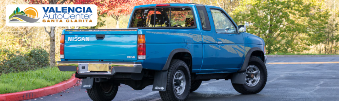 Pre-owned 4x4 pickup truck parked at Valencia Auto Center, ready for sale