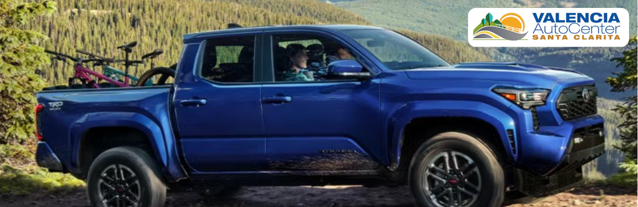 Used trucks lined up on the lot at Valencia Auto Center in Santa Clarita.