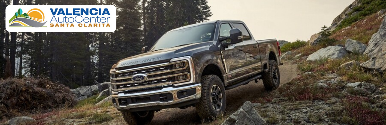 Customer exploring pre-owned truck options with a sales specialist at Valencia Auto Center.
